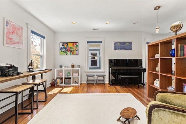 interior space featuring recessed lighting, baseboards, visible vents, and wood finished floors