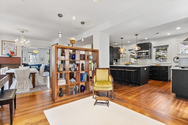 interior space featuring recessed lighting, light wood-style flooring, and a chandelier
