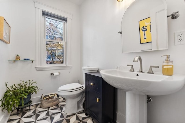 half bathroom featuring a sink and toilet