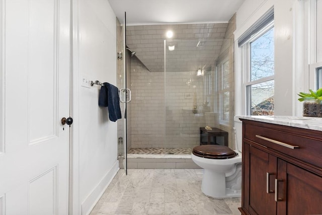 bathroom featuring vanity, a stall shower, toilet, and marble finish floor