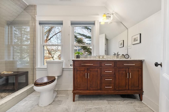full bathroom with vanity, baseboards, toilet, and lofted ceiling