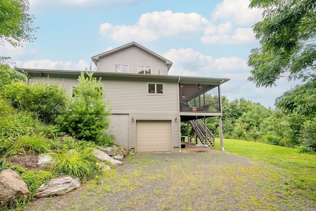 view of side of home featuring a yard and a garage