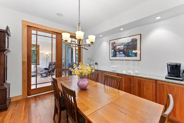 dining room featuring a notable chandelier and dark hardwood / wood-style flooring