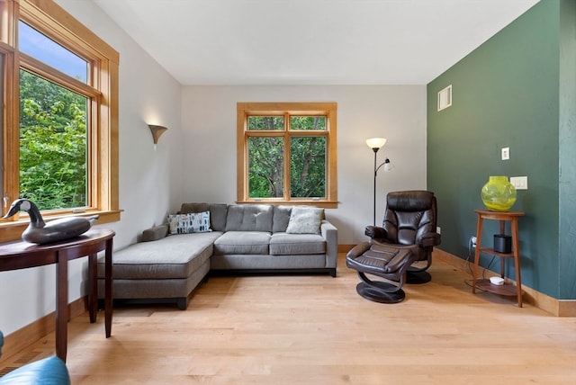 living room featuring light wood-type flooring and plenty of natural light