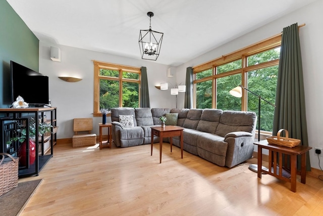 living room with an inviting chandelier and light hardwood / wood-style floors