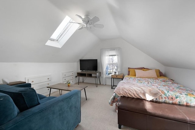 carpeted bedroom featuring ceiling fan and lofted ceiling with skylight