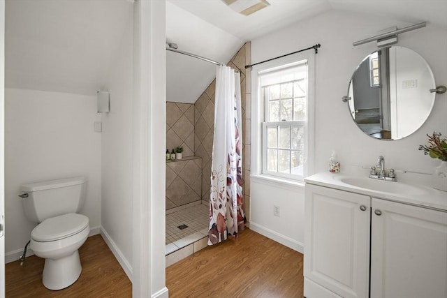 full bathroom featuring lofted ceiling, toilet, wood finished floors, baseboards, and tiled shower