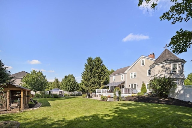 view of yard featuring fence and a wooden deck