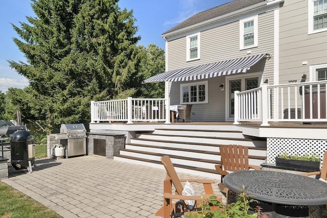 rear view of property with a patio area, stairway, a deck, and area for grilling