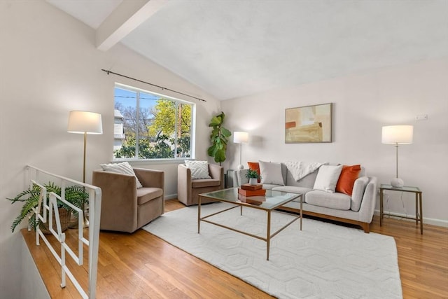 living room with baseboards, vaulted ceiling with beams, and wood finished floors