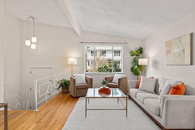 living area featuring light wood-style floors and vaulted ceiling with beams