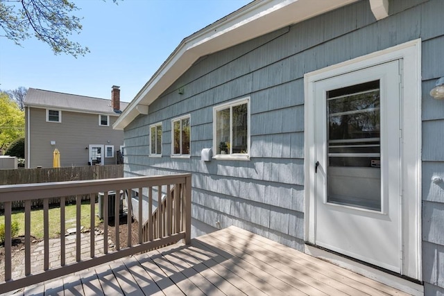 wooden terrace with central AC unit and fence