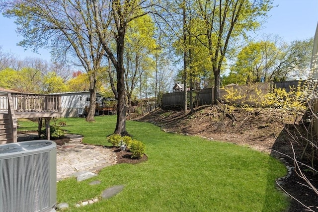 view of yard with fence, cooling unit, a patio, and a deck