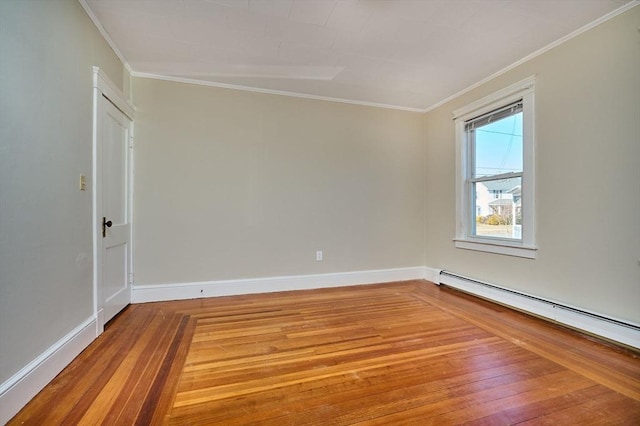 unfurnished room featuring a baseboard heating unit, wood-type flooring, baseboards, and ornamental molding