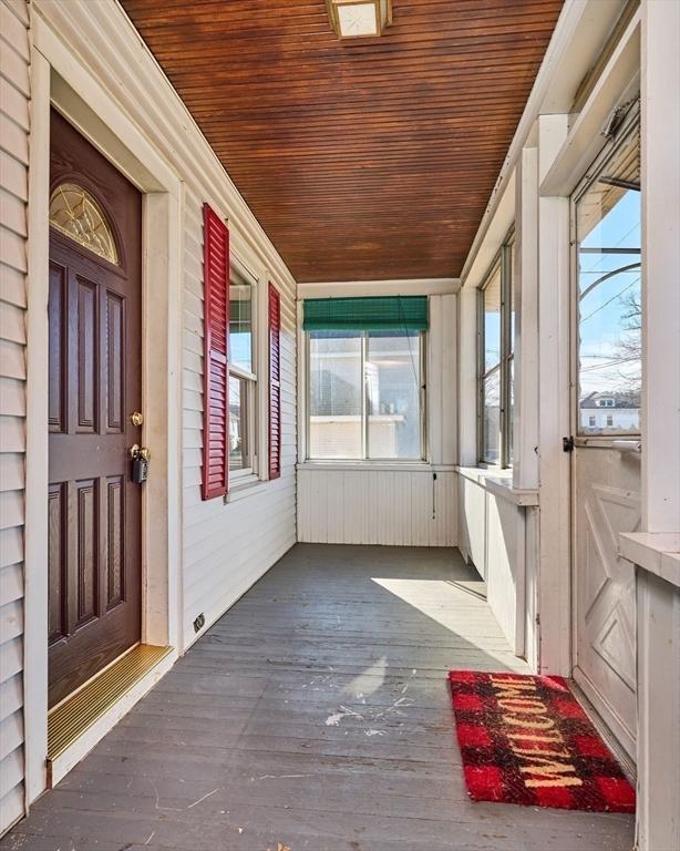 unfurnished sunroom featuring wooden ceiling