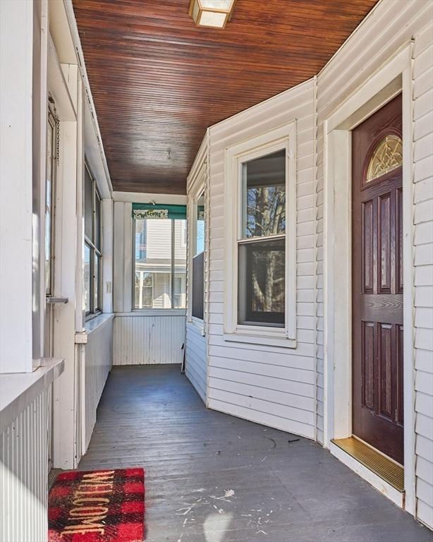 unfurnished sunroom with wooden ceiling