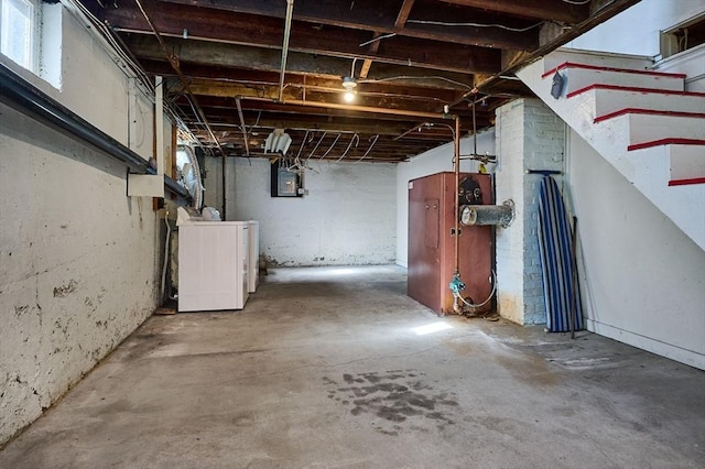 basement featuring electric panel and washer / dryer