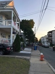 property exterior at dusk with covered porch