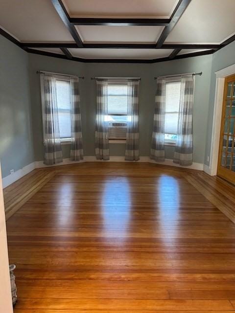 unfurnished room with light wood-type flooring and coffered ceiling