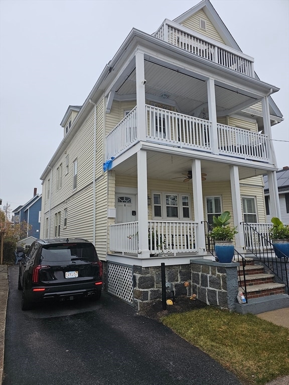 view of front facade featuring covered porch and a balcony