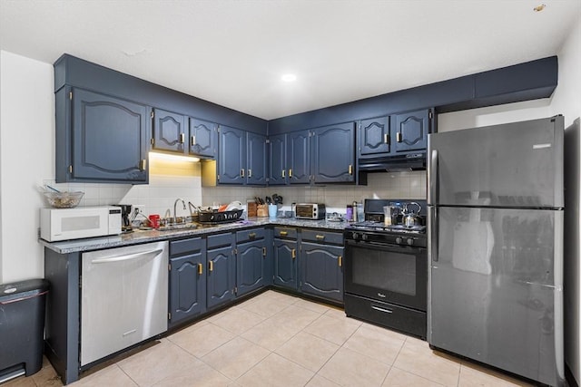 24 Inman St Unit 23, Lawrence, MA 01843 - kitchen with freestanding refrigerator, black range with gas stovetop, white microwave, dishwasher, and under cabinet range hood