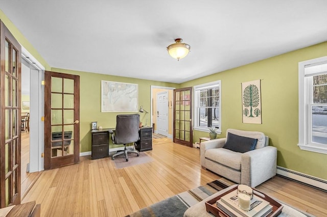 office area featuring a baseboard radiator, light hardwood / wood-style floors, and french doors