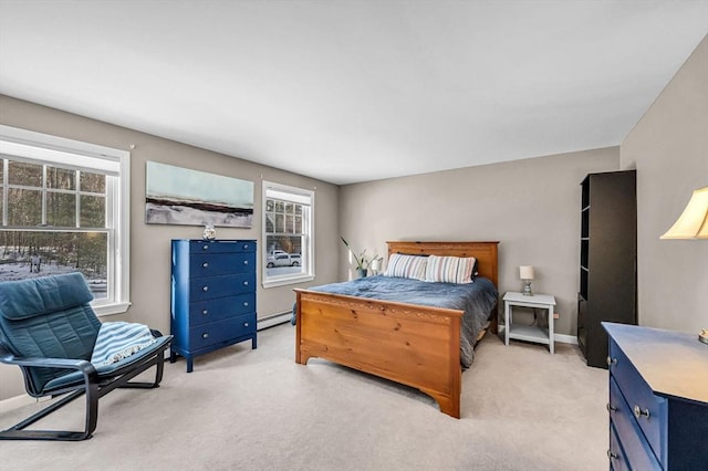 bedroom with light carpet and baseboard heating