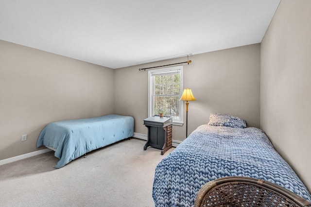 bedroom with light colored carpet and baseboard heating