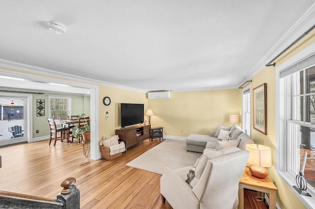 living room featuring crown molding, a wall mounted AC, and light hardwood / wood-style floors