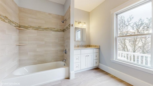 bathroom with vanity and tiled shower / bath