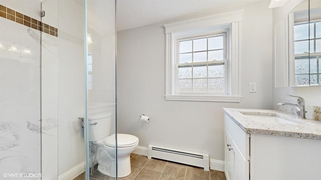 bathroom with vanity, a baseboard radiator, a shower with shower door, and a healthy amount of sunlight