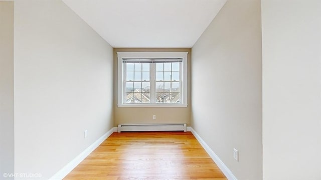 spare room with light hardwood / wood-style flooring and a baseboard heating unit