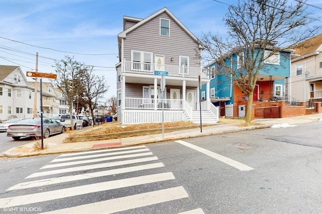 view of front of house featuring a balcony and covered porch