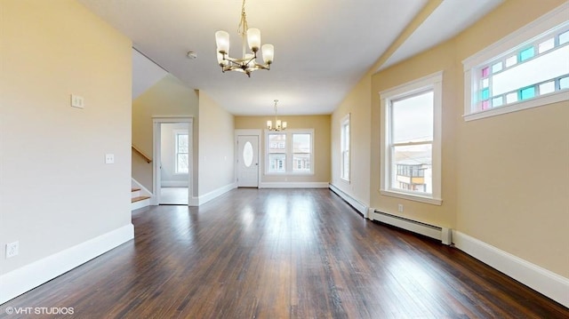 entrance foyer with a baseboard radiator, a notable chandelier, and dark hardwood / wood-style flooring