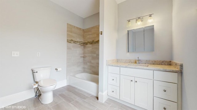 full bathroom featuring vanity, tiled shower / bath combo, and toilet