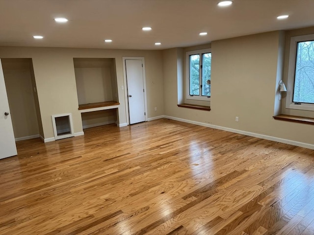 empty room featuring light wood-style floors, recessed lighting, and baseboards