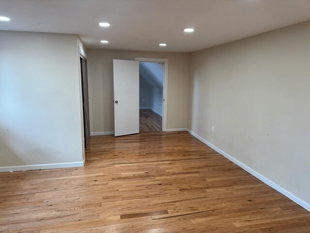 spare room with light wood-style flooring, baseboards, and recessed lighting