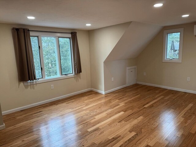 bonus room with recessed lighting, vaulted ceiling, baseboards, and wood finished floors