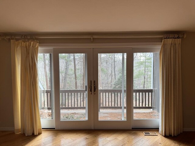 doorway to outside featuring light wood-style flooring and visible vents