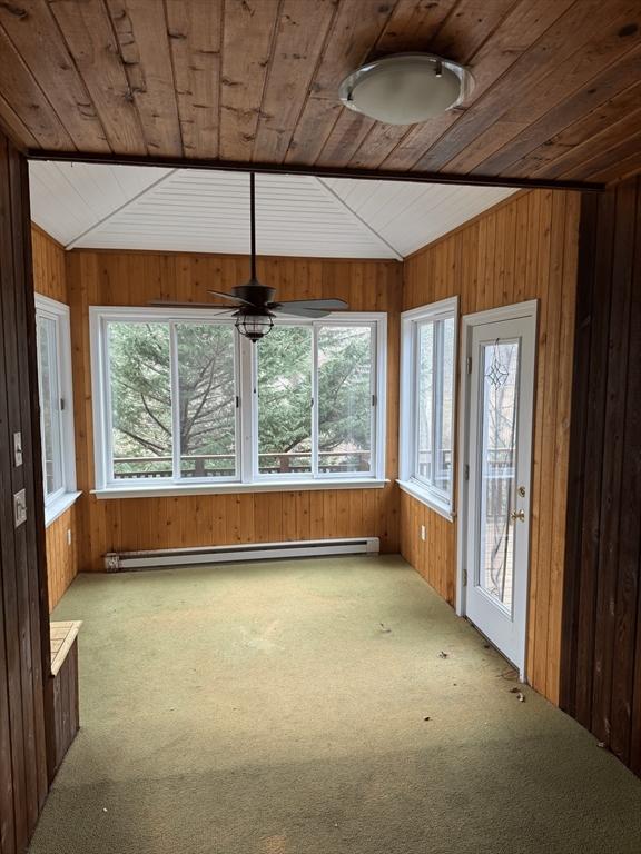 unfurnished sunroom featuring a baseboard heating unit, wooden ceiling, and lofted ceiling