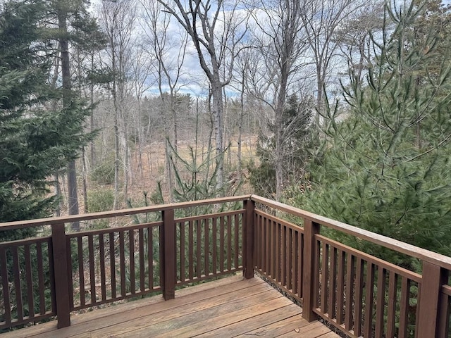 wooden deck featuring a view of trees