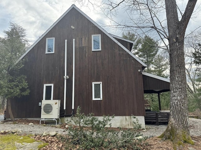 view of home's exterior featuring ac unit and a detached garage