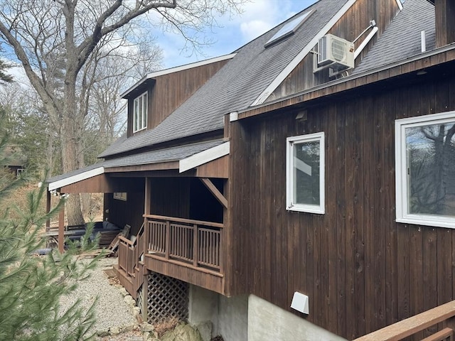 view of property exterior featuring a shingled roof and a porch