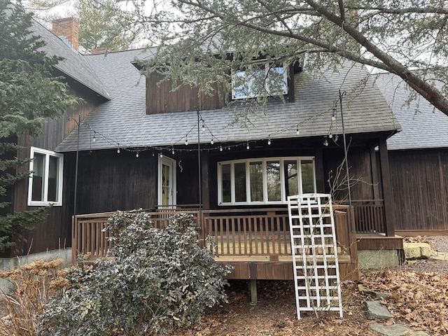 exterior space featuring roof with shingles