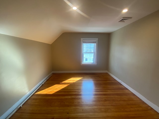 bonus room with vaulted ceiling and hardwood / wood-style flooring