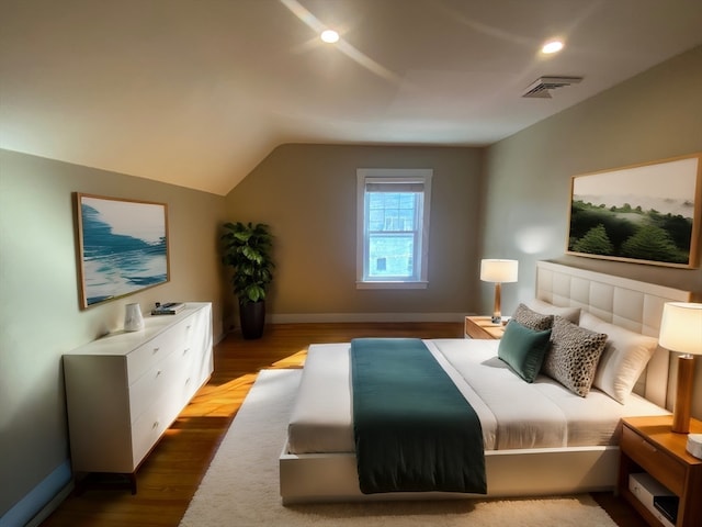 bedroom with wood-type flooring and lofted ceiling