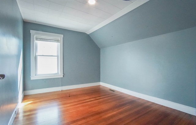 bonus room featuring vaulted ceiling and hardwood / wood-style floors