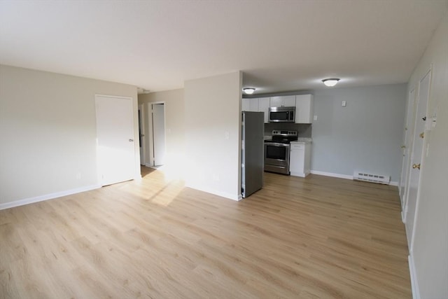 77 Nicholas Rd Unit I, Framingham, MA 01701 - unfurnished living room with a baseboard heating unit, light wood-style floors, and baseboards