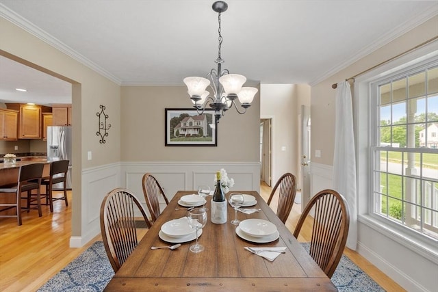 65 Saint Anthony St, Fitchburg, MA 01420 - dining area featuring light wood-style floors, a chandelier, wainscoting, and ornamental molding