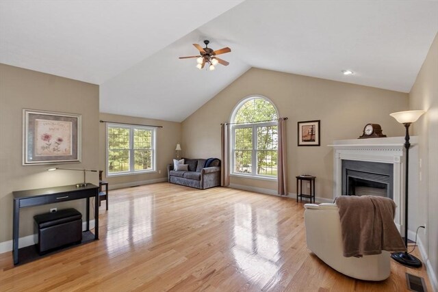 65 Saint Anthony St, Fitchburg, MA 01420 - living room featuring healthy amount of natural light, ceiling fan, light wood-style flooring, vaulted ceiling, and a fireplace
